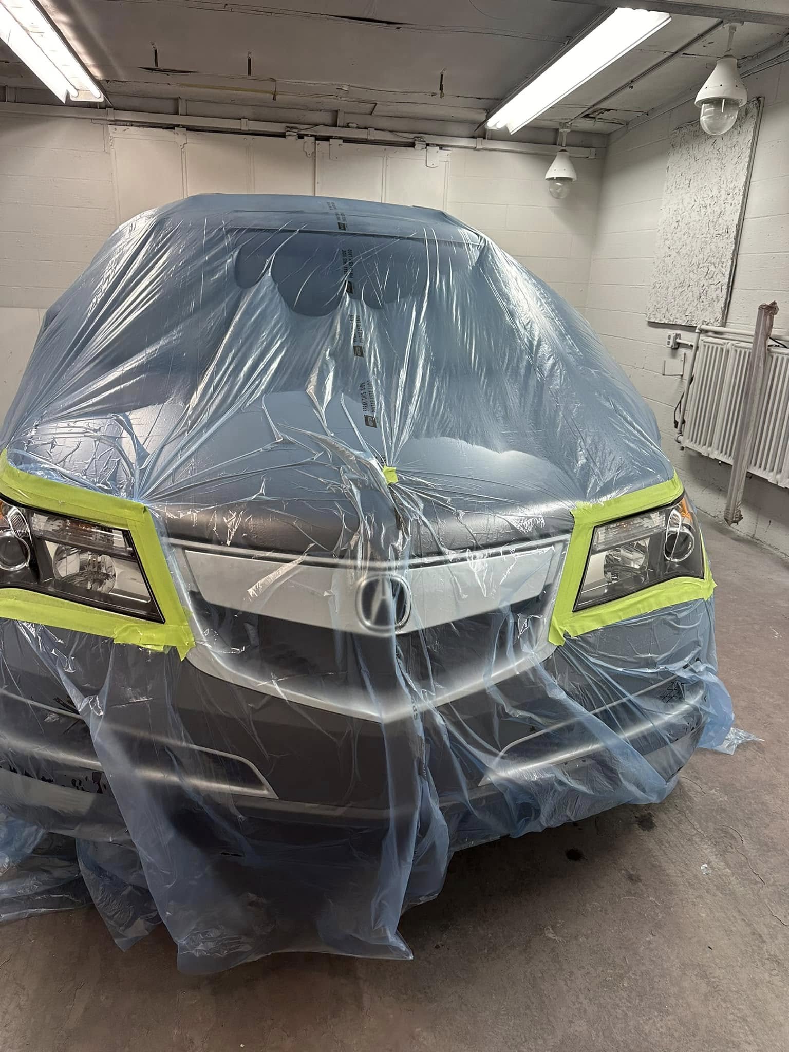 Vehicle fully masked and wrapped — professional paint prep